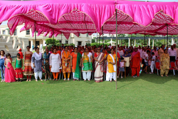 Rohtak, Haryana,  India – August 15, 2018: Group of real people from rural India standing together in the respect of National anthem during Independence day celebration event outdoor in the park.